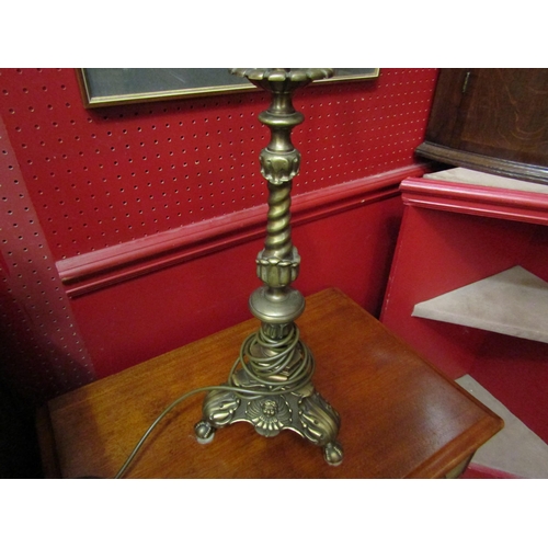 4145 - An ornate brass twin bulb electric table lamp on a decorative base with ball in claw feet