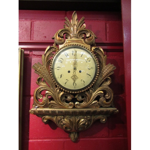 4176 - A 19th Century French cartel clock with Arabic numerals to the cream face, within a gilded ornately ... 