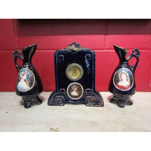 4178 - A Josef Strnact early 20th Century clock with a matching pair of ewers, cobalt blue glazed and havin... 