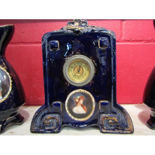 4178 - A Josef Strnact early 20th Century clock with a matching pair of ewers, cobalt blue glazed and havin... 