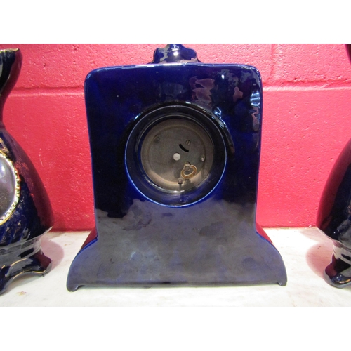 4178 - A Josef Strnact early 20th Century clock with a matching pair of ewers, cobalt blue glazed and havin... 