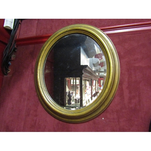 4223 - A circular painted gilt wall mirror with bevel edge, 61cm x 53cm total