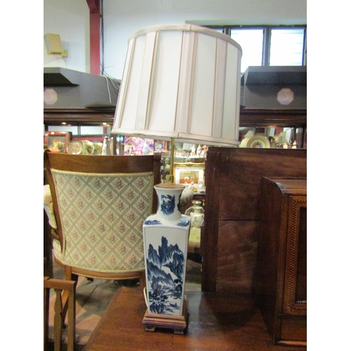 4231 - A circa mid-20th Century Chinese blue and white table lamp with pleated shade on wooden base