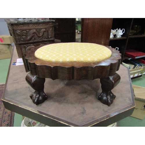 4239 - A 19th Century heavy hardwood footstool the shaped sides over ball in claw cabriole feet, 23cm high ... 