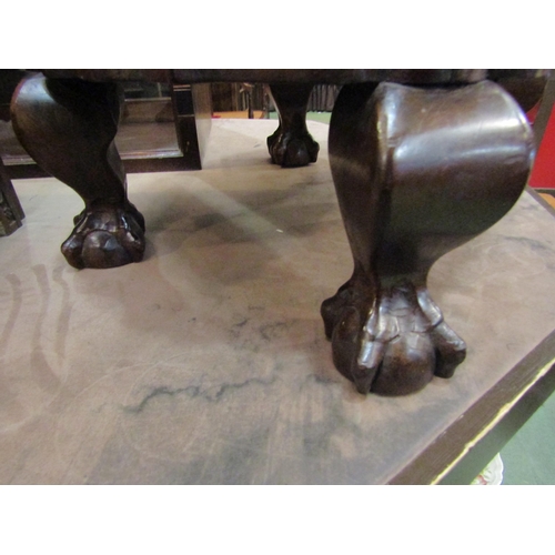 4239 - A 19th Century heavy hardwood footstool the shaped sides over ball in claw cabriole feet, 23cm high ... 