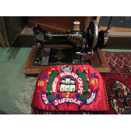 4262 - A late Victorian sewing machine with case and key, model no. 153645 and a red hand-embroidered tea c... 