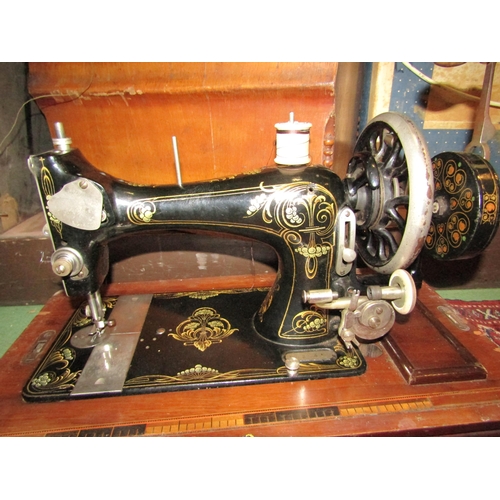 4262 - A late Victorian sewing machine with case and key, model no. 153645 and a red hand-embroidered tea c... 