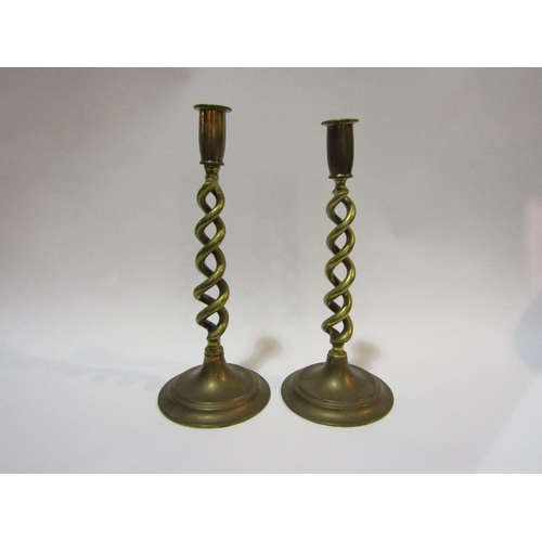 4312 - A pair of open-twist brass candlesticks, 31cm high