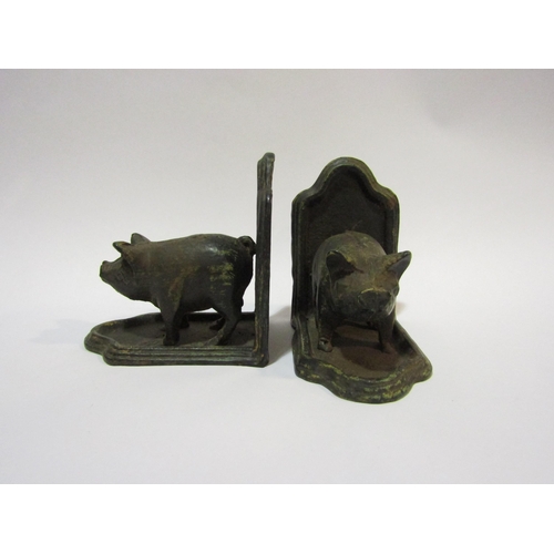 4313 - A pair of metal bookends with pig design, 12cm high