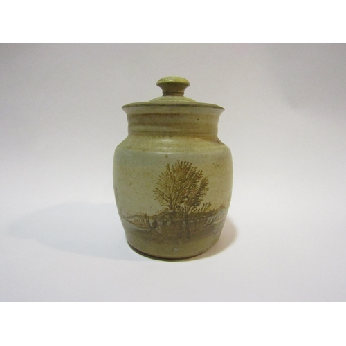 4323 - A Studio pottery lidded jar depicting trees and naturalistic setting, 17cm high   (R)  £10