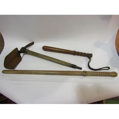 4339 - A First World War entrenching tool with wooden handle and bayonet mount, together with a bygone poli... 