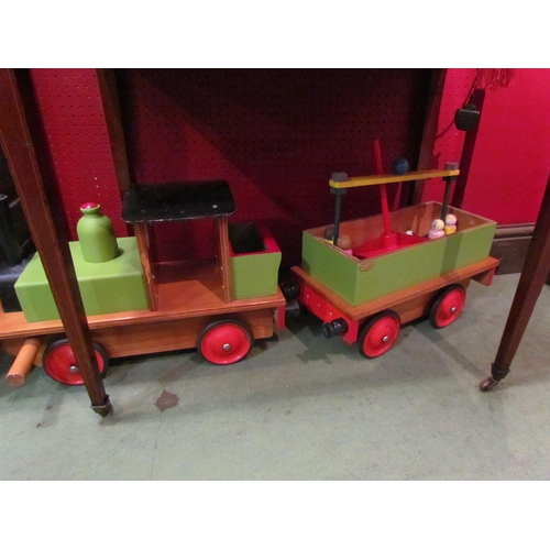 4104 - A vintage painted wooden locomotive and tender toy, with similar wooden carousel and figures