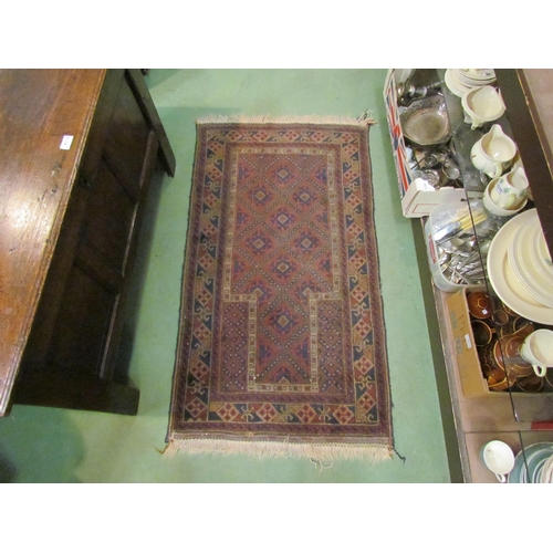 4219 - An Eastern saddle bag, 110cm x 64cm, and a red ground rug with multiple patterned borders, 128cm x 7... 