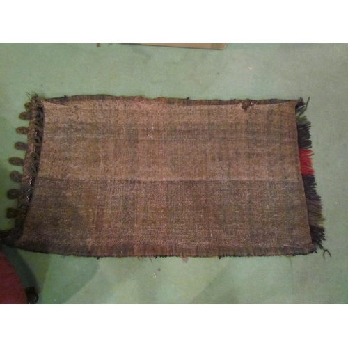 4219 - An Eastern saddle bag, 110cm x 64cm, and a red ground rug with multiple patterned borders, 128cm x 7... 