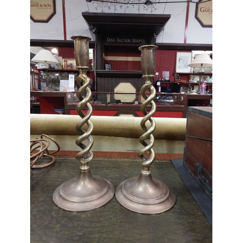 4312 - A pair of open-twist brass candlesticks, 31cm high