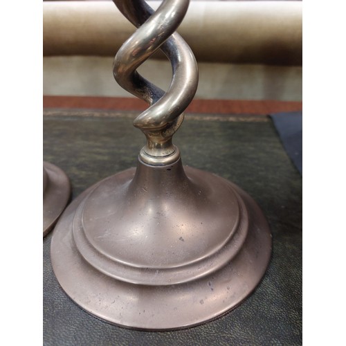 4312 - A pair of open-twist brass candlesticks, 31cm high