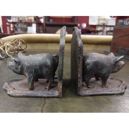 4313 - A pair of metal bookends with pig design, 12cm high