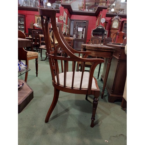 4135 - An Arts & Crafts walnut open armchair in the manner of Jas. Shoolbred with spindle backrest the serp... 