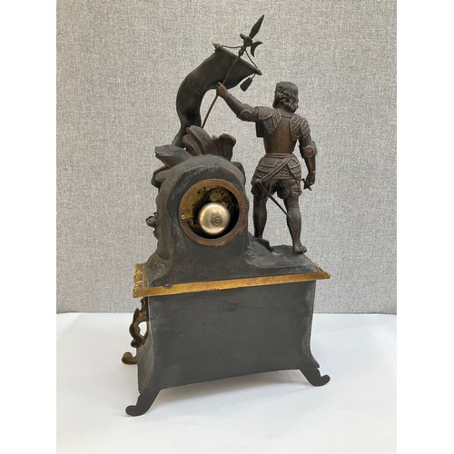 7001 - A late 19th Century mantel clock, the bronzed spelter top with flag bearer beside enamelled face (da... 