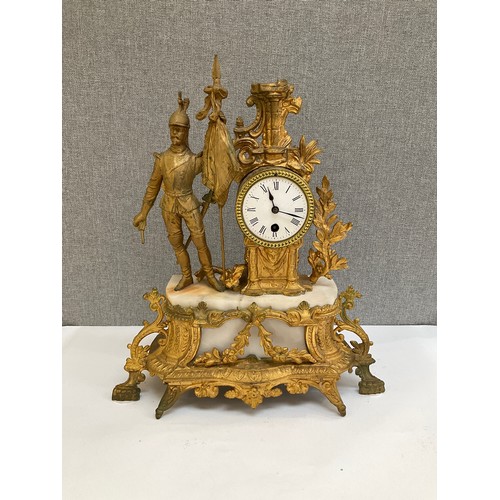 7009 - A late 19th Century French figural mantel clock with flag bearer figure, 45cm tall, loose foliage a/... 