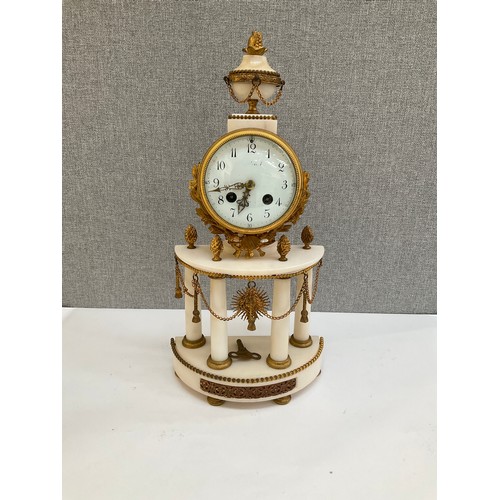 7010 - A 19th Century French alabaster and ormolu mantel clock with Arabic dial and column detail, sun-form... 