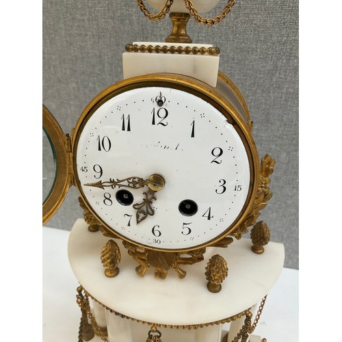 7010 - A 19th Century French alabaster and ormolu mantel clock with Arabic dial and column detail, sun-form... 