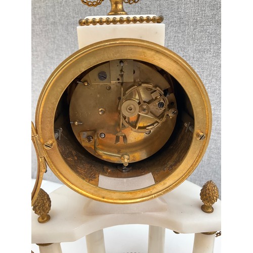 7010 - A 19th Century French alabaster and ormolu mantel clock with Arabic dial and column detail, sun-form... 