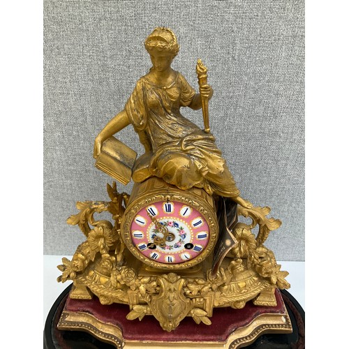 7011 - A 19th Century French ormolu figural mantel clock, surmounted by a maiden, scroll and foliate design... 