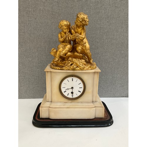 7012 - A 19th Century French alabaster mantel clock, gilded figural top, cracked to reverse, glass missing,... 