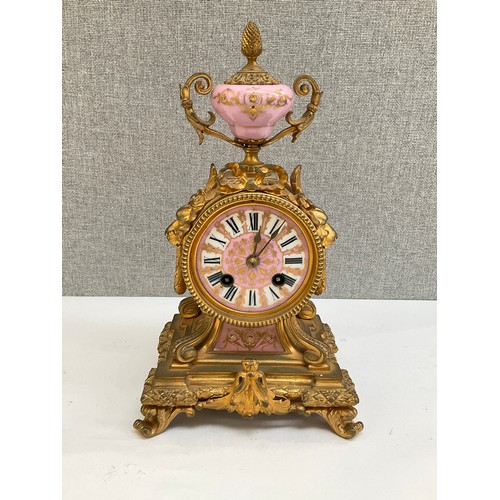 7013 - A 19th Century French mantel timepiece, ormolu case with pink and white porcelain face and lower pan... 