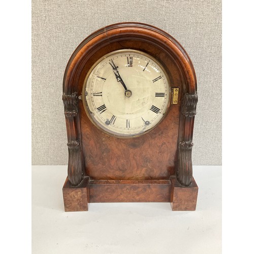 7015 - A 19th Century walnut cased mantel clock with arched top, carved sides, Roman numerated dial, Wymond... 