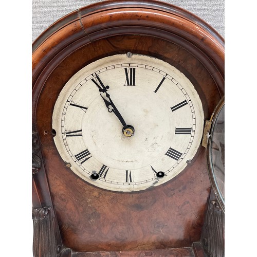 7015 - A 19th Century walnut cased mantel clock with arched top, carved sides, Roman numerated dial, Wymond... 