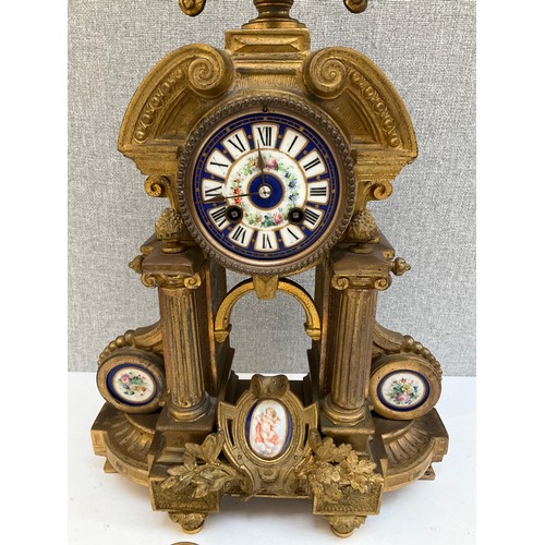 7028 - A 19th Century French ormolu mantel clock of Architectural form with Sevres style porcelain face pan... 