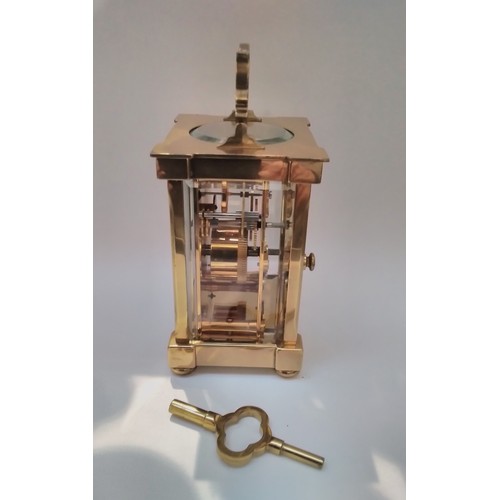 7319 - A 20th Century Matthew Norman of London brass carriage clock, 23cm tall x 8.5cm wide, with key