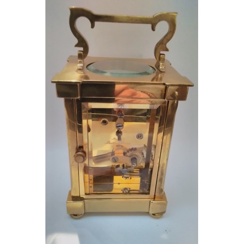 7319 - A 20th Century Matthew Norman of London brass carriage clock, 23cm tall x 8.5cm wide, with key