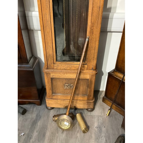 7098 - A 1920s oak long case clock with brass Arabic dial, bevelled glazing, with pendulum and weights