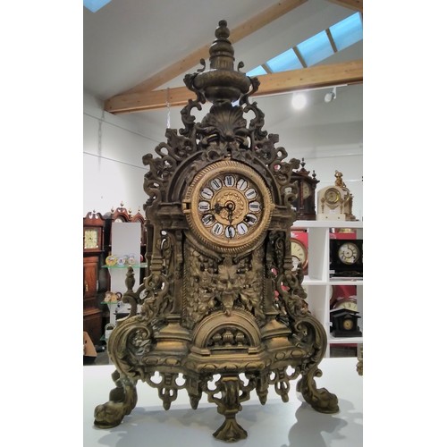 7290 - A 20th Century heavy cast brass mantel clock with scrolled detail