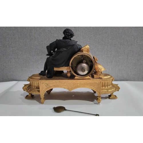 7294 - A 19th Century French ormolu mantel clock with painted ceramic face and panel, figural detail, with ... 