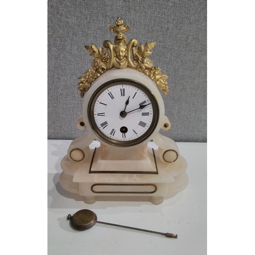 7292 - Two alabaster mantel clocks, one surmounted by lion, one with face damaged, both with pendulums