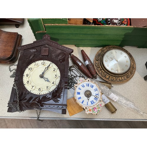 7123 - A Bakelite cased cuckoo clock, made in USSR, together with a Metamec wall clock and a Continental po... 