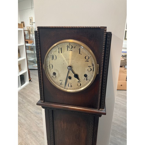 7185 - A 1920s oak cased Grandmother clock with Arabic metallic dial and beaded detail, with pendulum