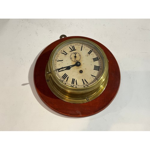 7246 - A brass cased ship's clock mounted on hardwood plaque   (E)  £35-45