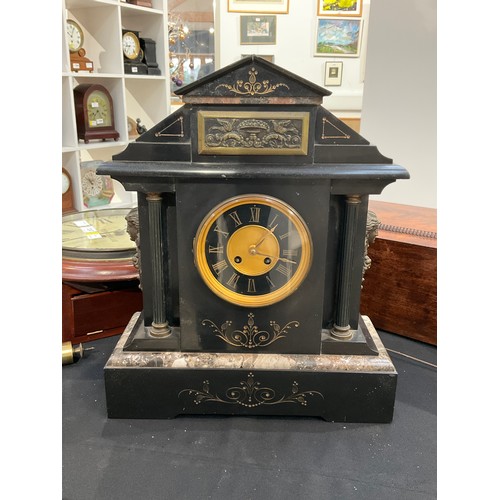 7250 - A circa 1900 black slate and marble mantel clock with Roman chapter ring, brass relief plaque to top... 