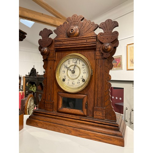 7255 - An early 20th Century Welch R. Greene of Norwich imported walnut cased mantel clock, fretwork detail... 