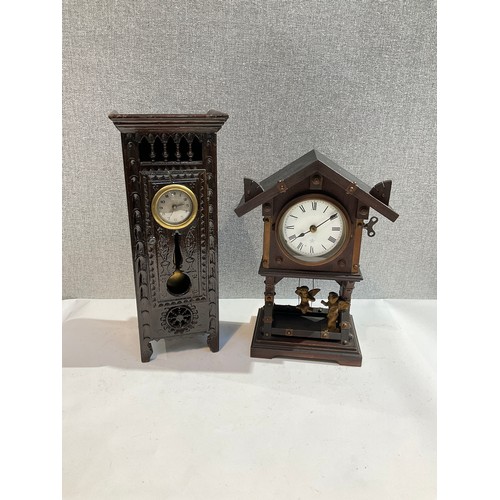 7258 - A carved wood miniature long case clock, together with a cherubic pendulum architectural form clock ... 