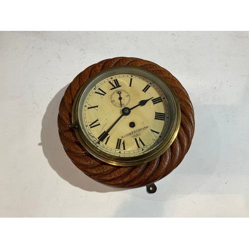 7261 - A B. Cooke and Sons of Hull ship's clock with oak rope twist case, 22cm diameter