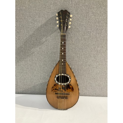 5111 - A George Morley of London retailed round back mandolin with tortoiseshell effect guard, segmented ba... 