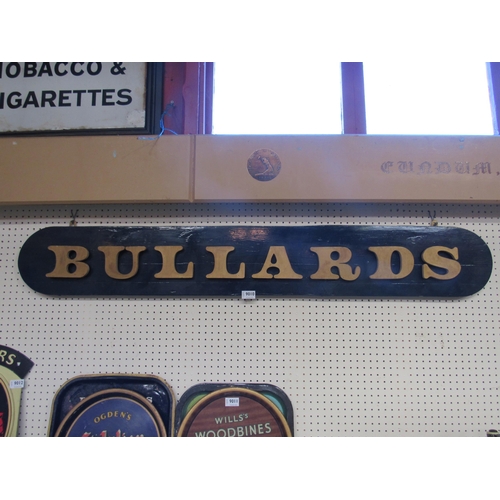 9010 - A wooden Bullards sign, 54