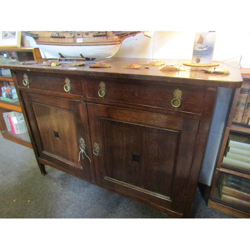 1060 - A dark oak two drawer, two door sideboard in the Arts & Crafts style, 95cm high x 139cm wide x 59cm ... 