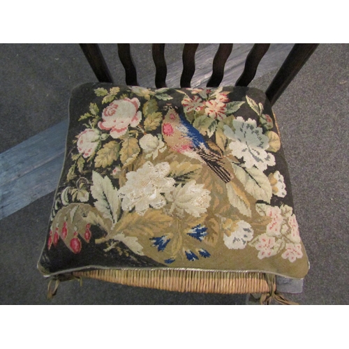 1006 - An Arts & Crafts nursing chair, wavy back splats with rush seat and needlepoint pillow